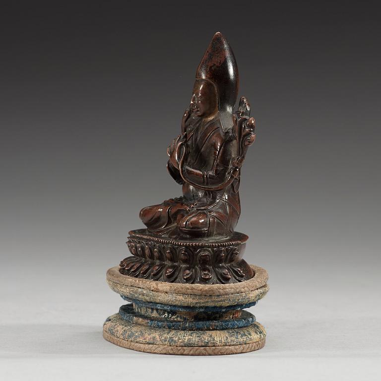 A copper alloy seated figure of a Tsong Khapa, presumably Nepal, 19th Century or older.