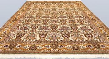 A part silk Ghom carpet, c. 420 x 310 cm.