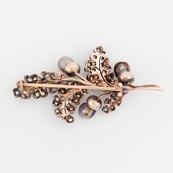 A silver and gold brooch set with pearls and rose-cut diamonds.