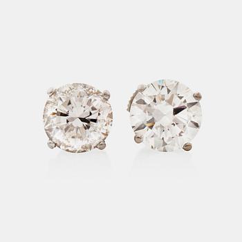 1327. A pair of solitaire dbrilliant-cut diamond earrings. Total carat weight circa 4.20 cts.