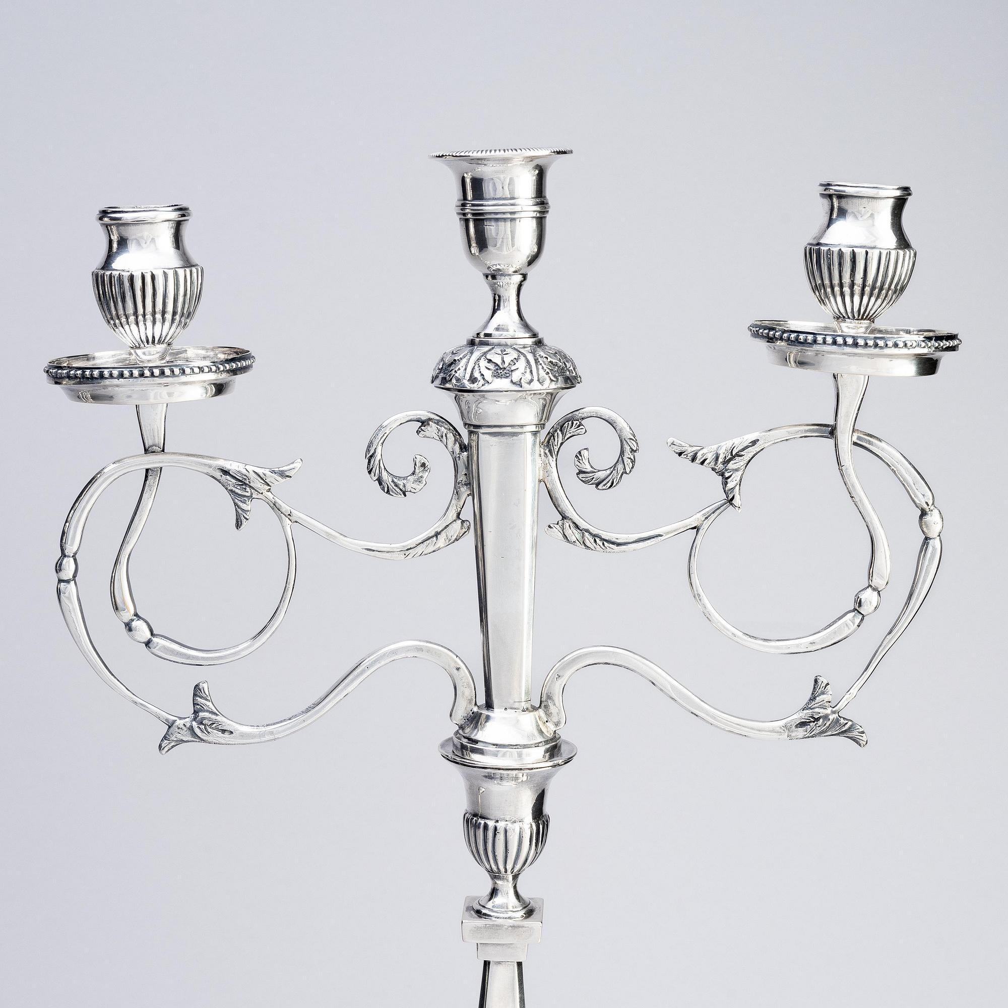 A pair of Swedish silver candelabras, marks of Pehr Zethelius, Stockholm 1797 and Daniel Hedberg, Eksjö 1829.