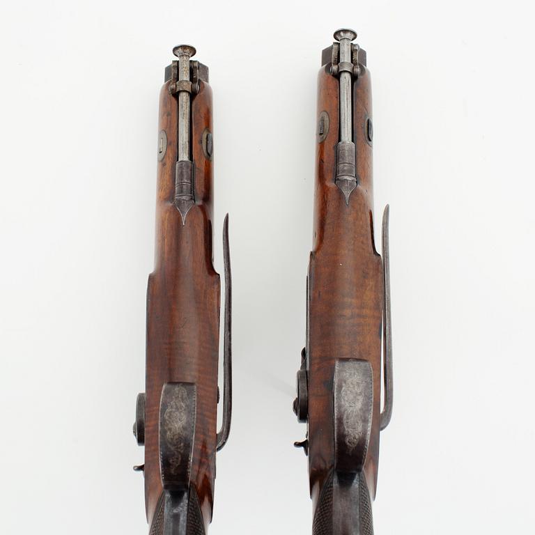 A cased pair of percussion pistols by Westley Richards, London, mid 19th Century.