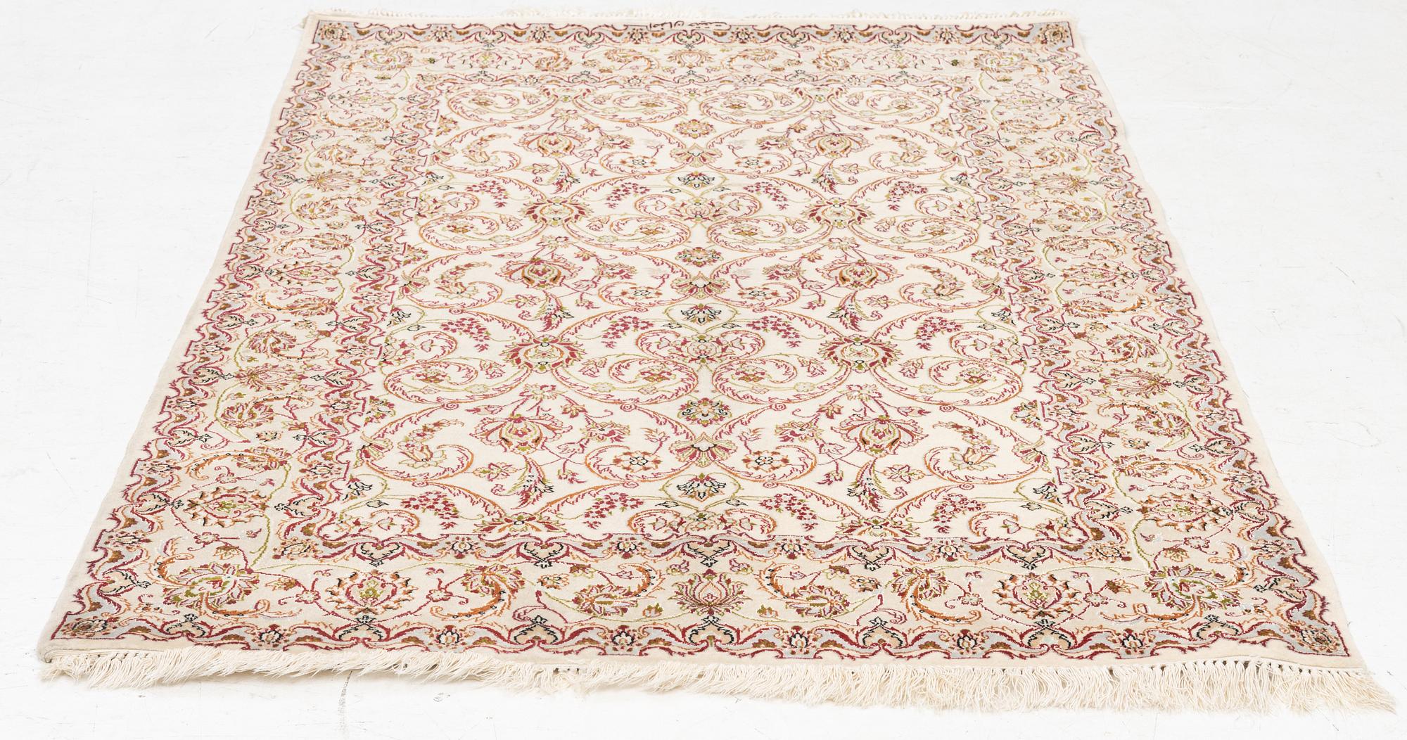 An Isfahan, part silk rug, signed, c. 165 x 112 cm.