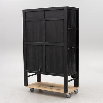 A red-lacquered cabinet, China, 20th century.