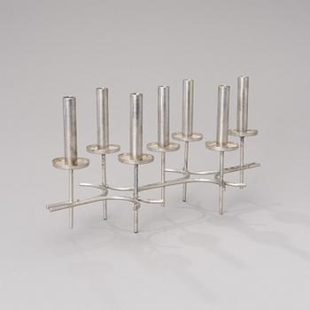 A candle holder stamped Paavo Tynell.