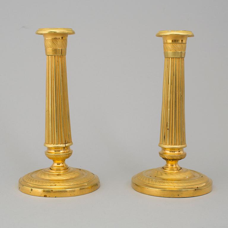 A PAIR OF EMPIRE CANDLESTICKS, first half of the 19th century.