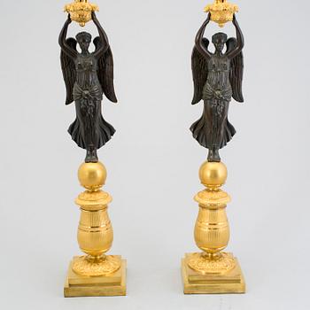 A large pair of first half of the 19th century gilt and patinated bronze five-light candelabra.