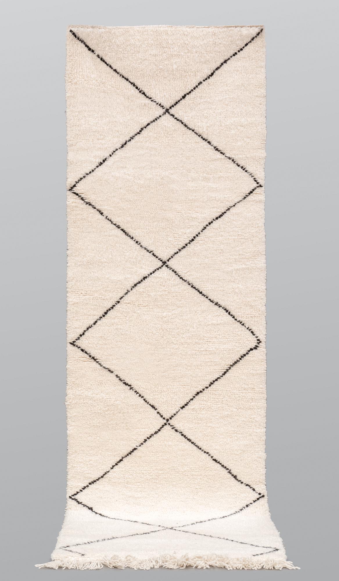 A Moroccan runner carpet, 300 x 88 cm.