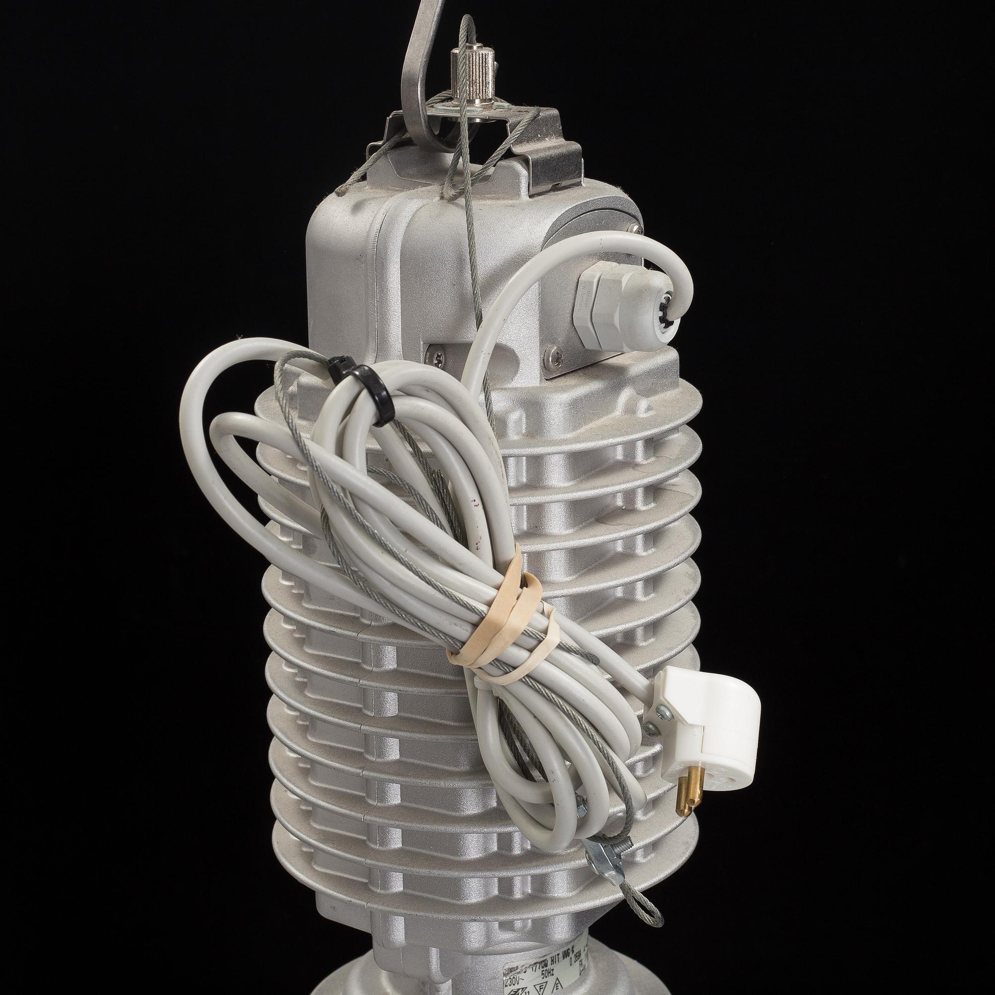 An industrial ceiling lamp marked Zumtobel Staff.