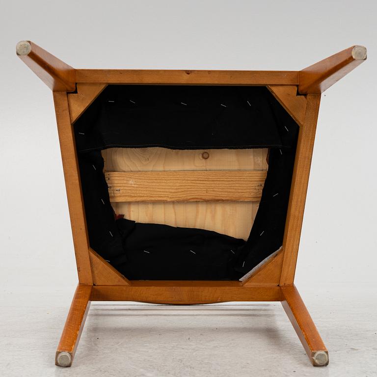 A dining table with four chairs, mid 20th century.