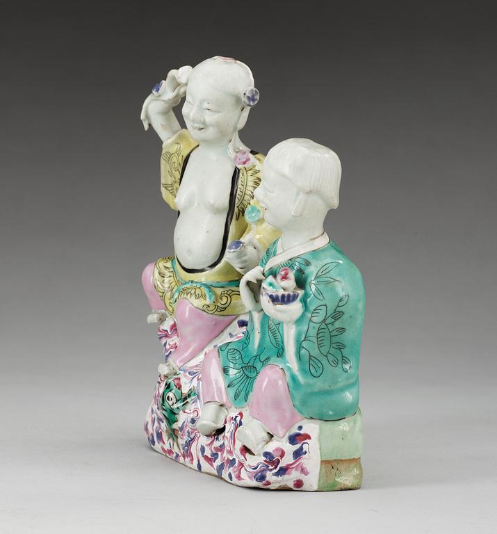 A famille rose figure of two boys, Qing dynasty, ca 1800.