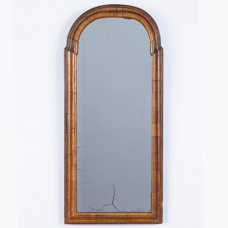A late Baroque walnut-veneered mirror, first part of the 18th century.