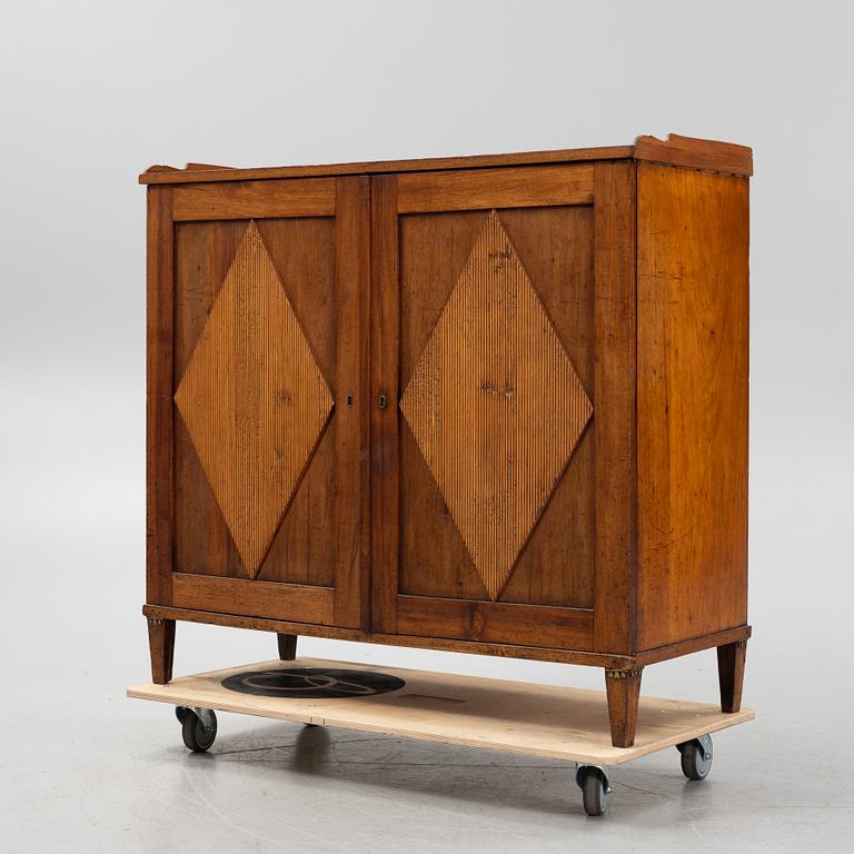 A Gustavian style mahognay veneered cupboard. 19th Century.