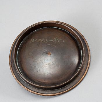 A Japanese iron tea pot with bronze cover, signed.