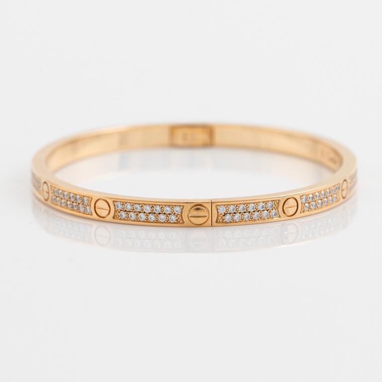 A Cartier "Love" bracelet small model in 18K gold set with round brilliant-cut diamonds.