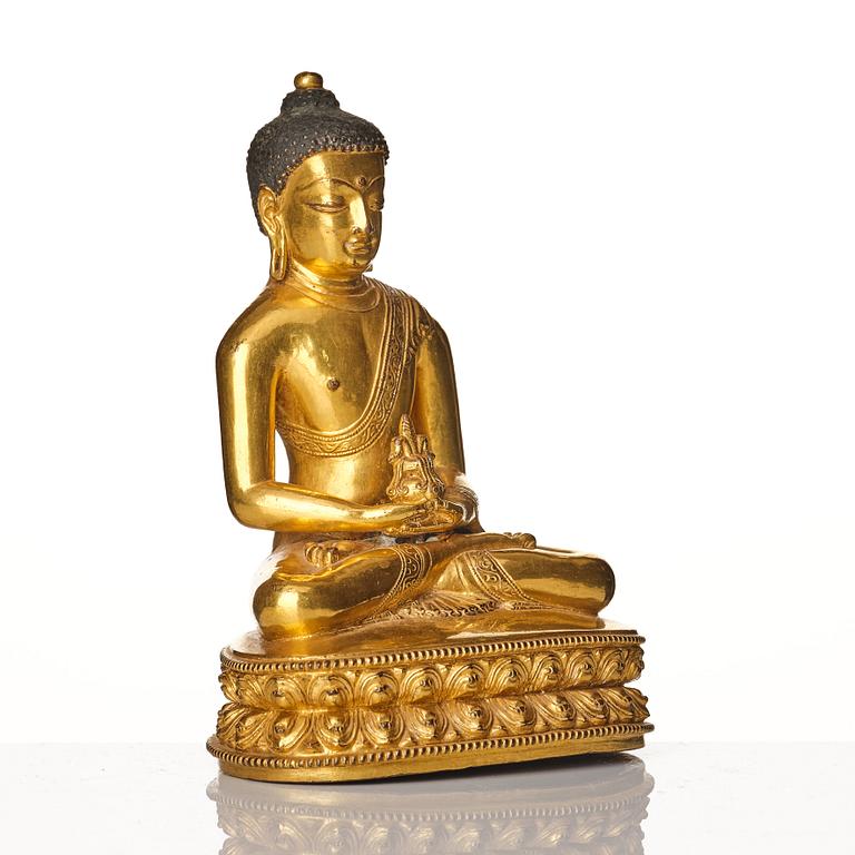 A gilt copper alloy figure of buddha, Tibeto Nepalese, stylistically from the 14th/15th Century,