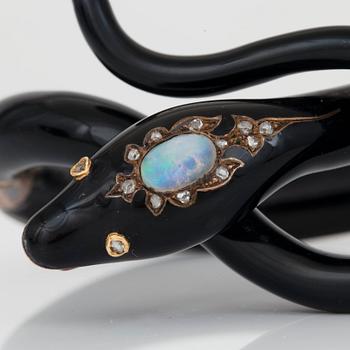 A Victorian snake bracelet in black enamel set with an opal and rose-cut diamonds.