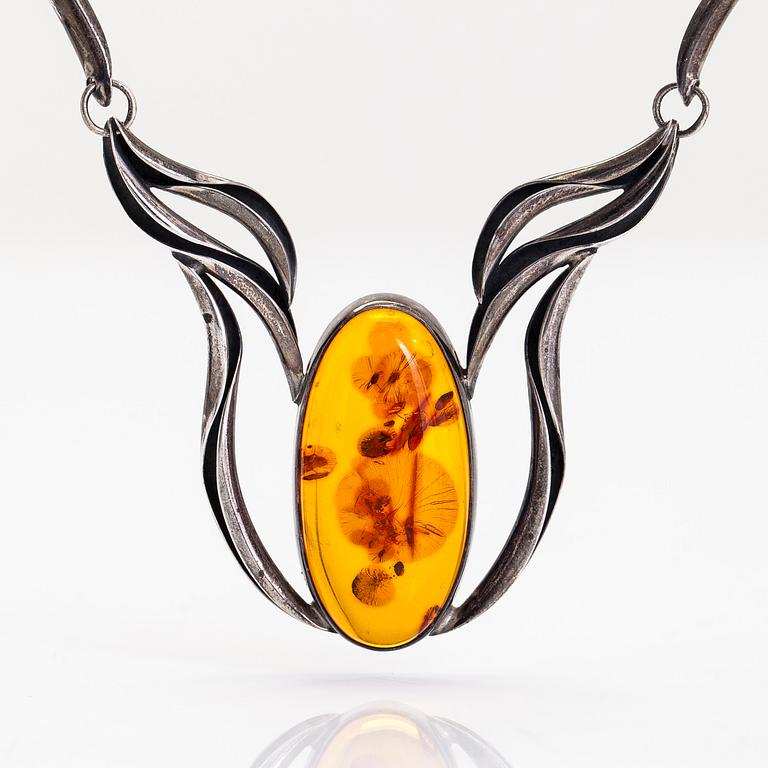 A silver and amber necklace.