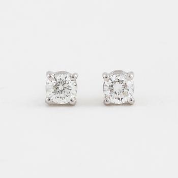 A pair of brilliant cut diamond earrings.