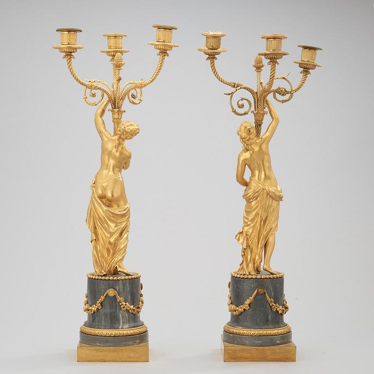 A pair of Louis XVI circa 1780 three-light gilt bronze and bleu turquin marble candelabra.