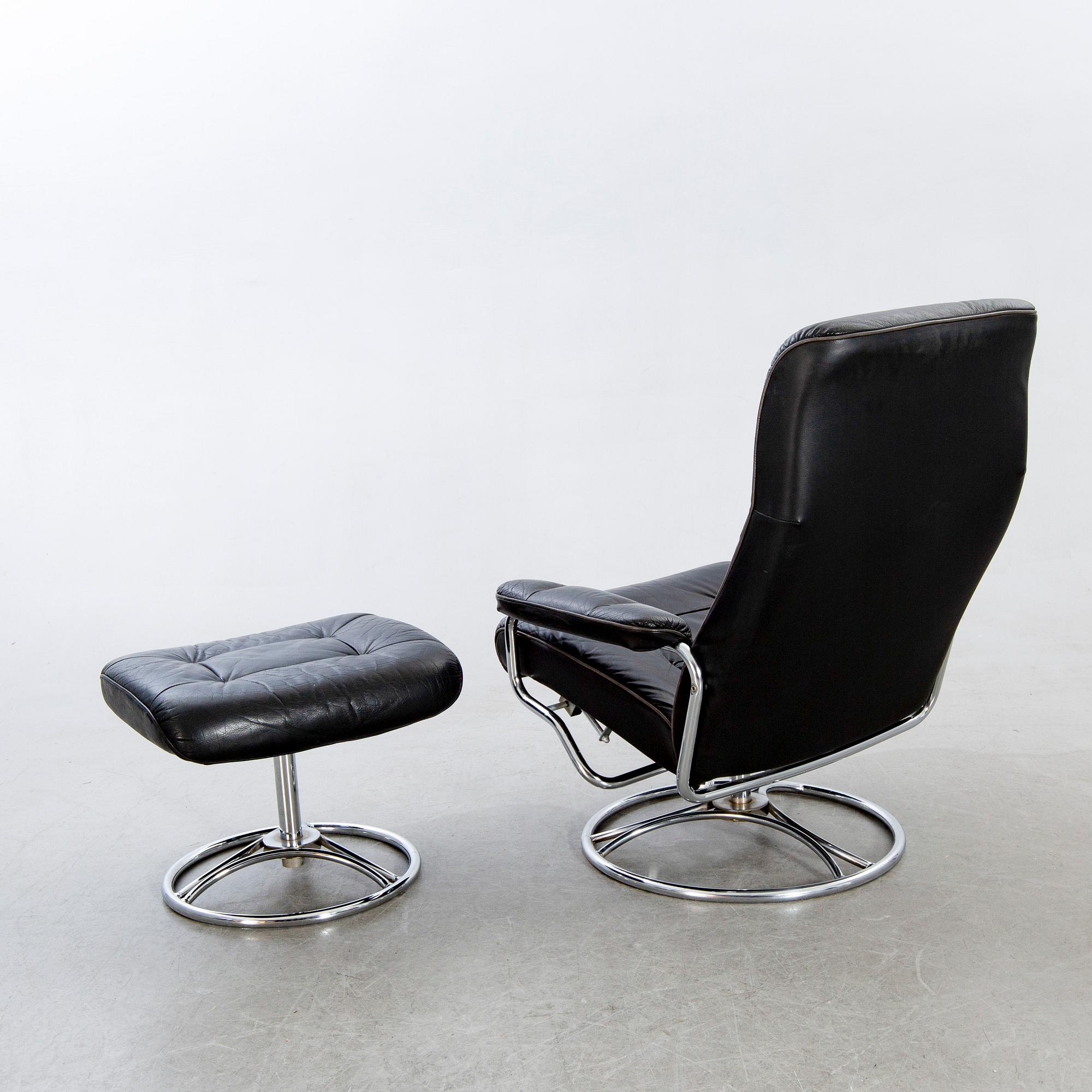 A leather swivel armchair and stool, Söderbergs  1980s.