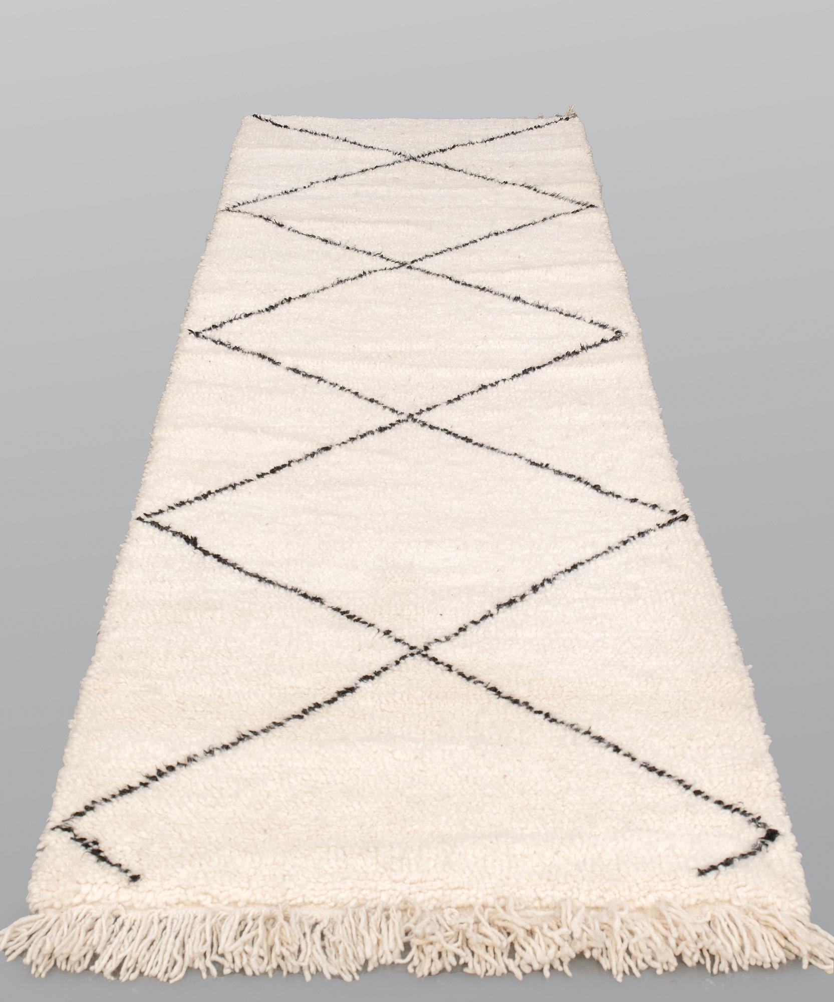A Moroccan runner carpet, 300 x 88 cm.