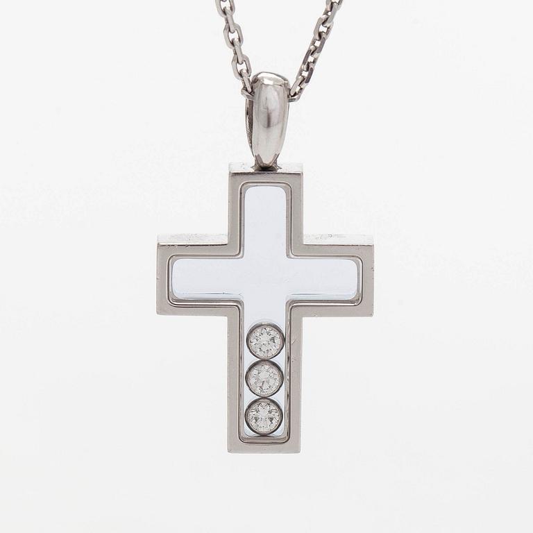 Chopard, an 18K whitegold 'Happy Diamonds" cross necklace set with diamonds.