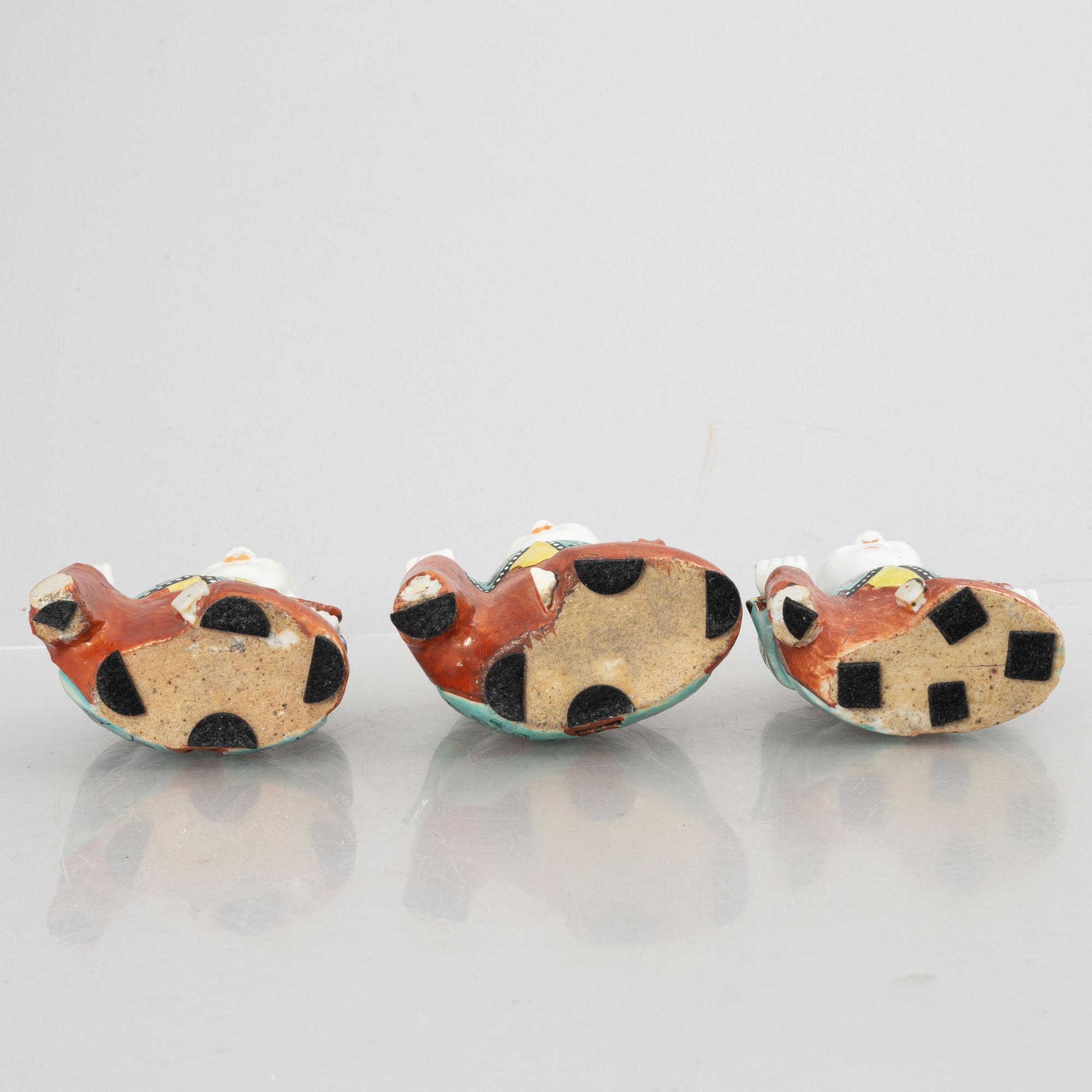 A group of three Chinese porcelain 'Laughing boys' figures, Qing dynasty and later.