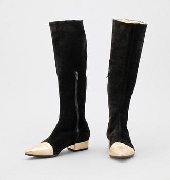 A pair of black suede boots by Versace.