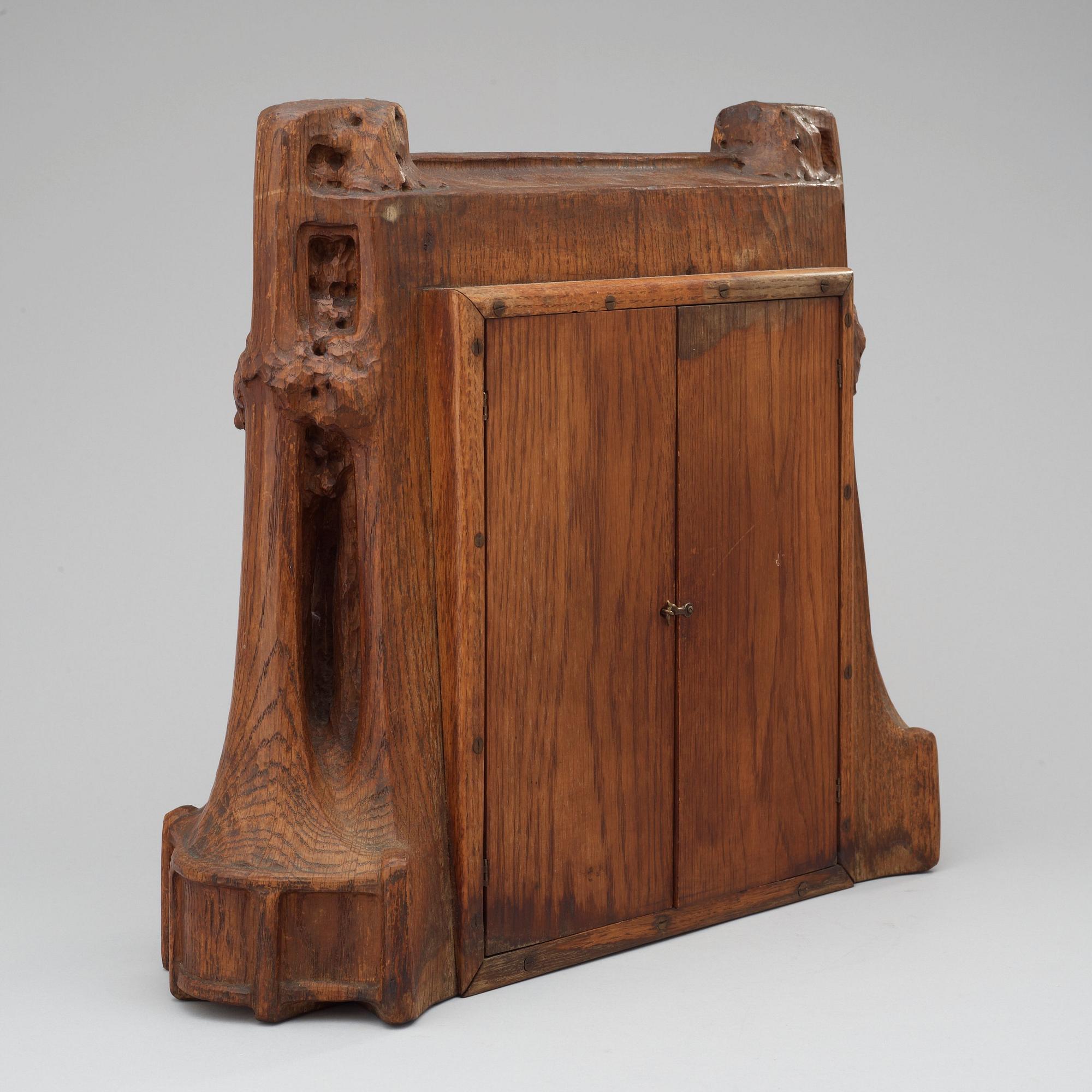 A Swedish Art Nouveau carved pine mantel clock, probably by Rackengruppen.