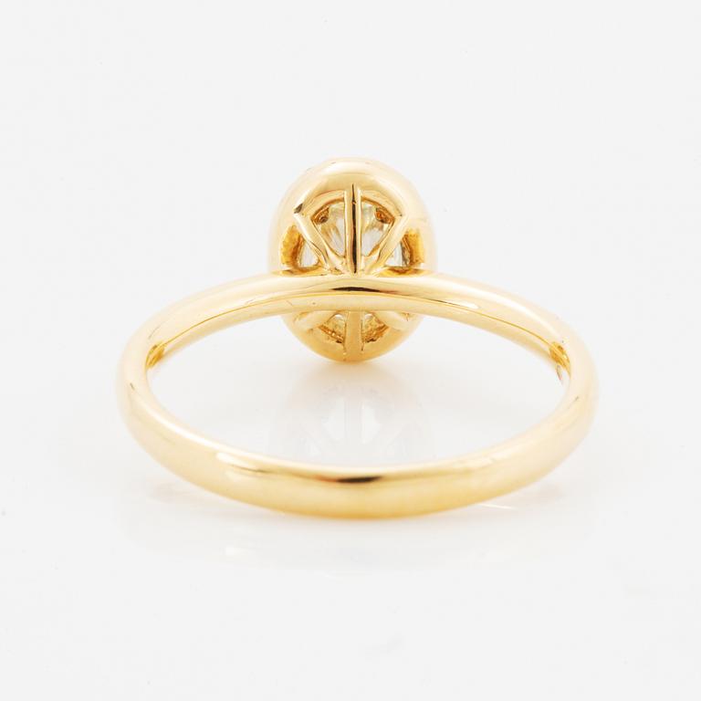 Oval light yellow diamond and brilliant-cut diamond ring.