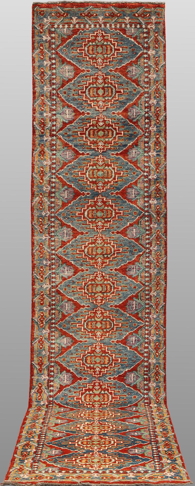 An oriental runner, c. 386 x 78 cm.