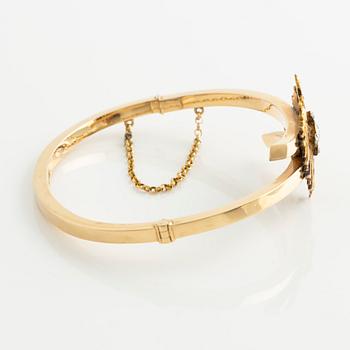 Armband 18K guld med en fastlödd del av en broschnål i guld med gammalslipade diamanter, i form av en örn.