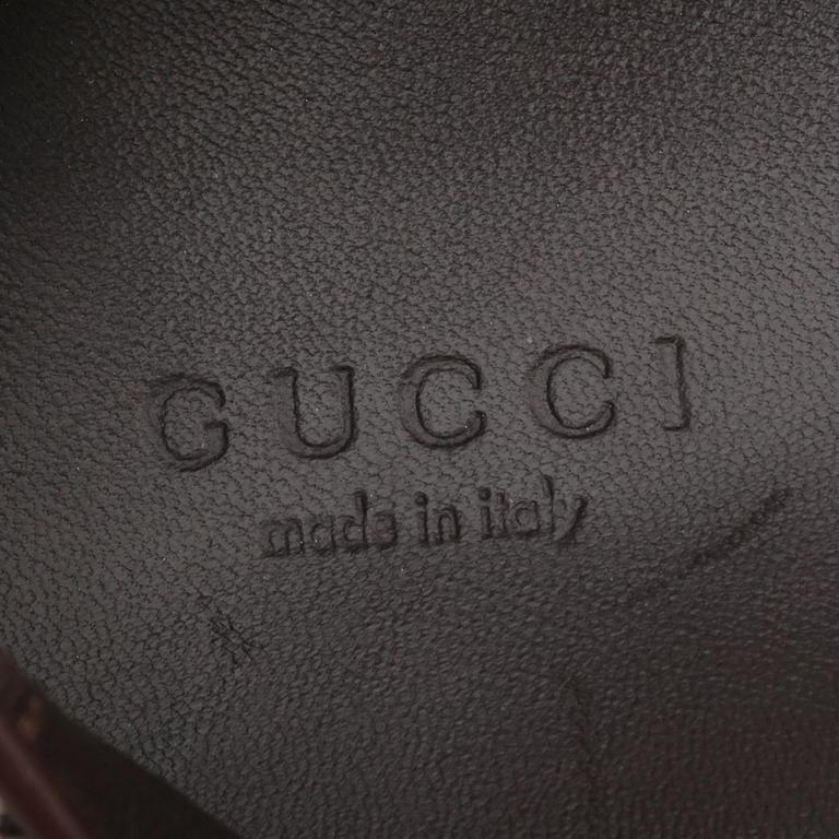 GUCCI, a pair of leopard patterned loafers.