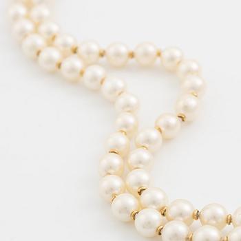A two strand cultured pearl necklace with an 18K gold clasp with a half-pearl and round brilliant-cut diamonds.