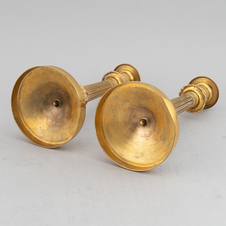 A circa 1900 empire style brass candlesticks.