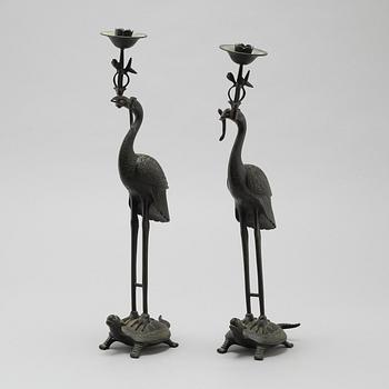 A pair of bronze candlesticks, China, 20th Century.