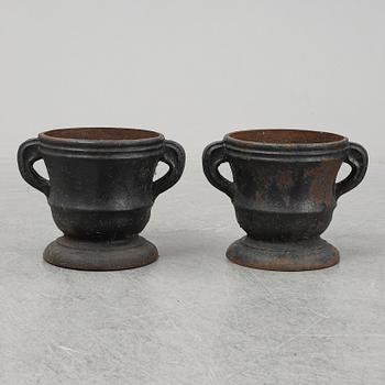 A 19th  century pair of cast iron flower pots.