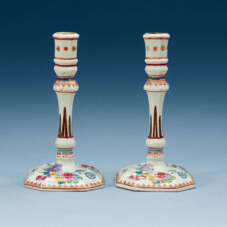 A pair of famille rose candle sticks, Qing dynasty, Qianlong (1736-95).