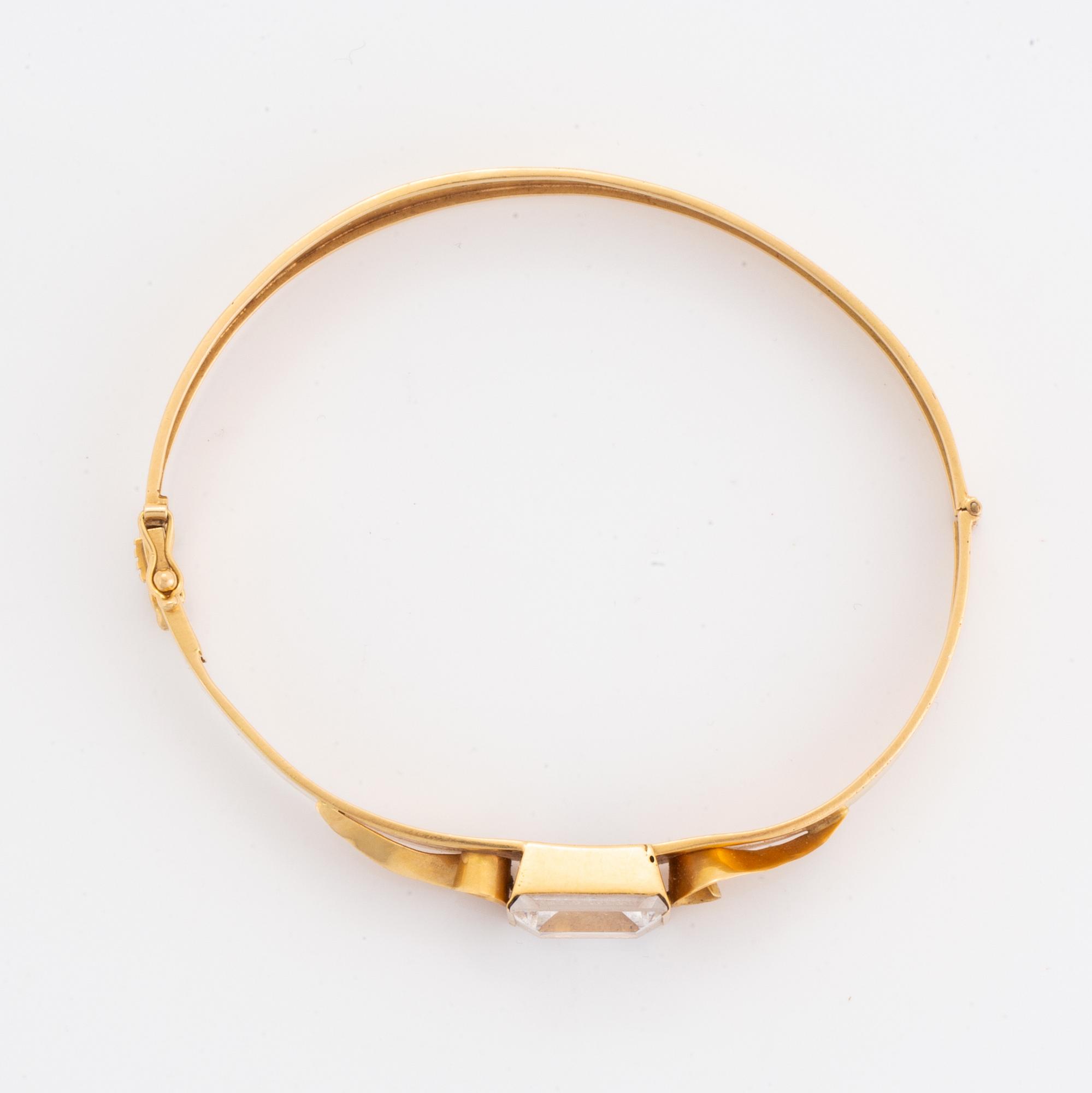 18K gold bangle and white synthetic stones.