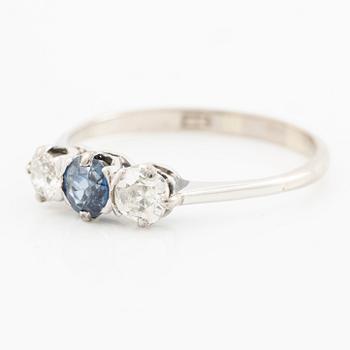 18K gold ring with two old-cut diamonds and a blue stone.