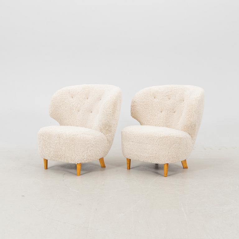 A pair of Scandinavian Modern 1940s cheepskin armchairs.
