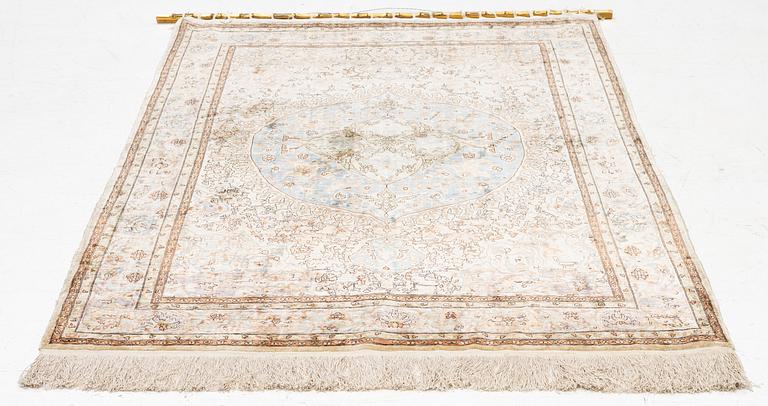 An oriental, silk rug, signed, c. 175 x 125 cm.