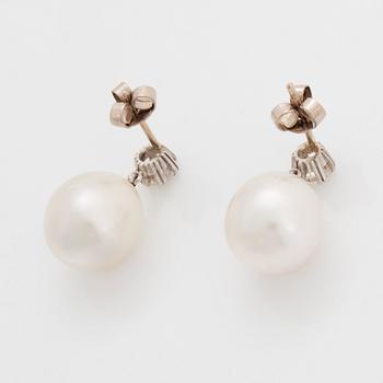 A pair of 18K white gold earrings set with round brilliant-cut diamonds and cultured pearls.