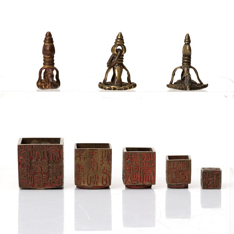 A set of four copper alloy and brass seals, India and China, 18th/19th Century.