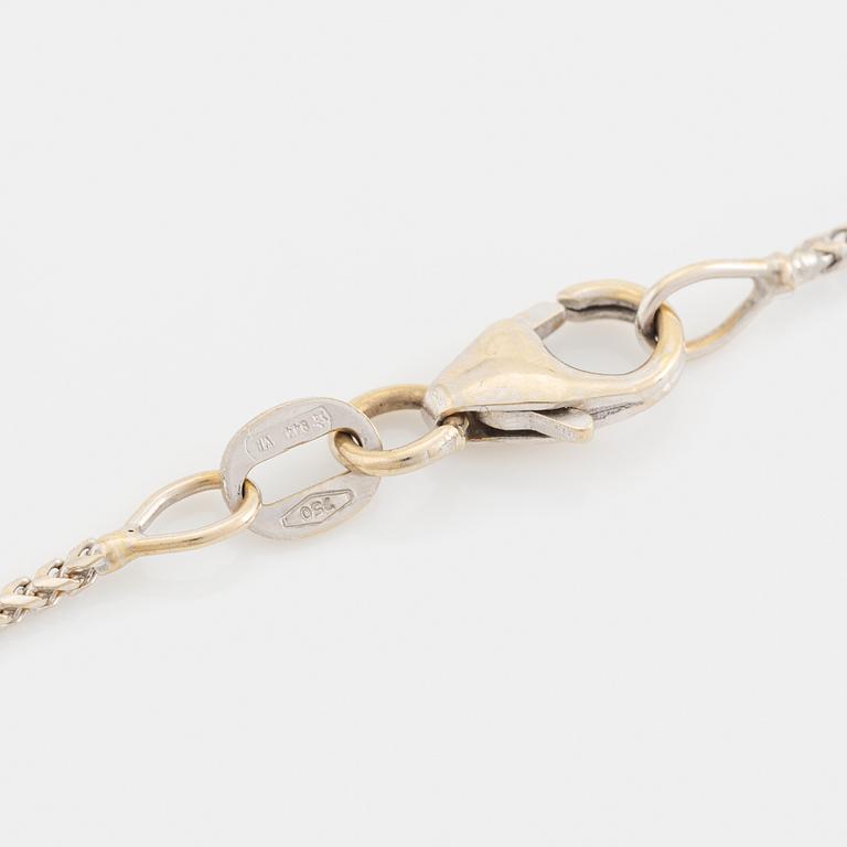 An 18K white gold necklace with a faceted sapphire.