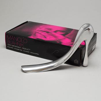 A metal shoe horn by Manolo Blahnik, with orignal box.