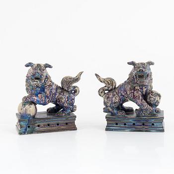 A pair of Chinese glazed stoneware buddhist lions, 20th century.