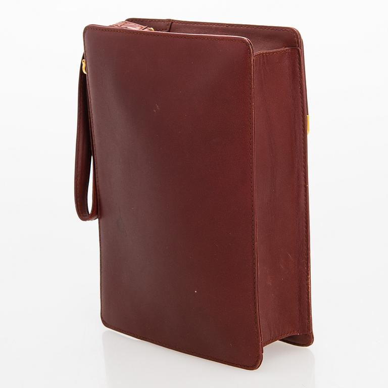 Must de Cartier bag clutch with accessories.