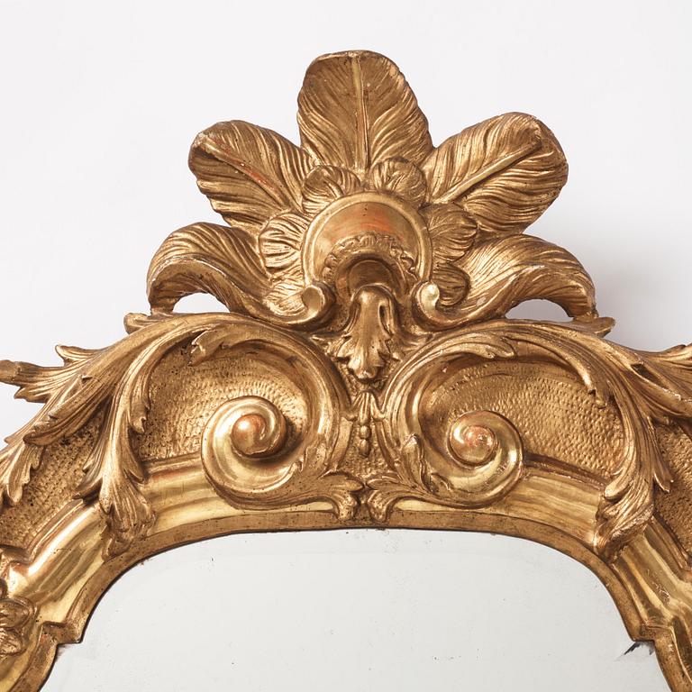 A presumably German giltwood rococo mirror, mid 18th century.